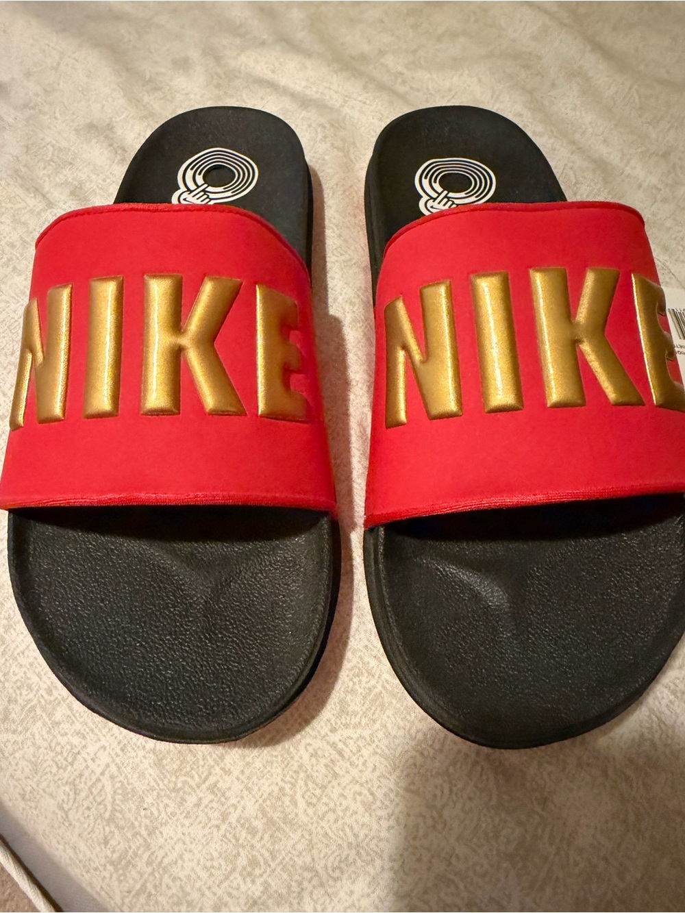 Nike Women’s Red Slide Sandals with Gold Logo Accent